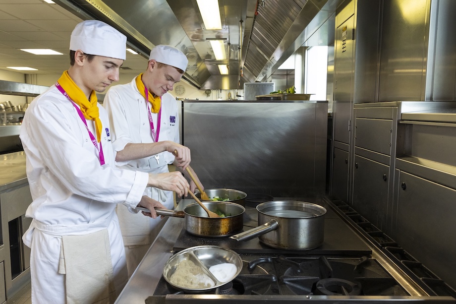 College chefs in kitchen cooking