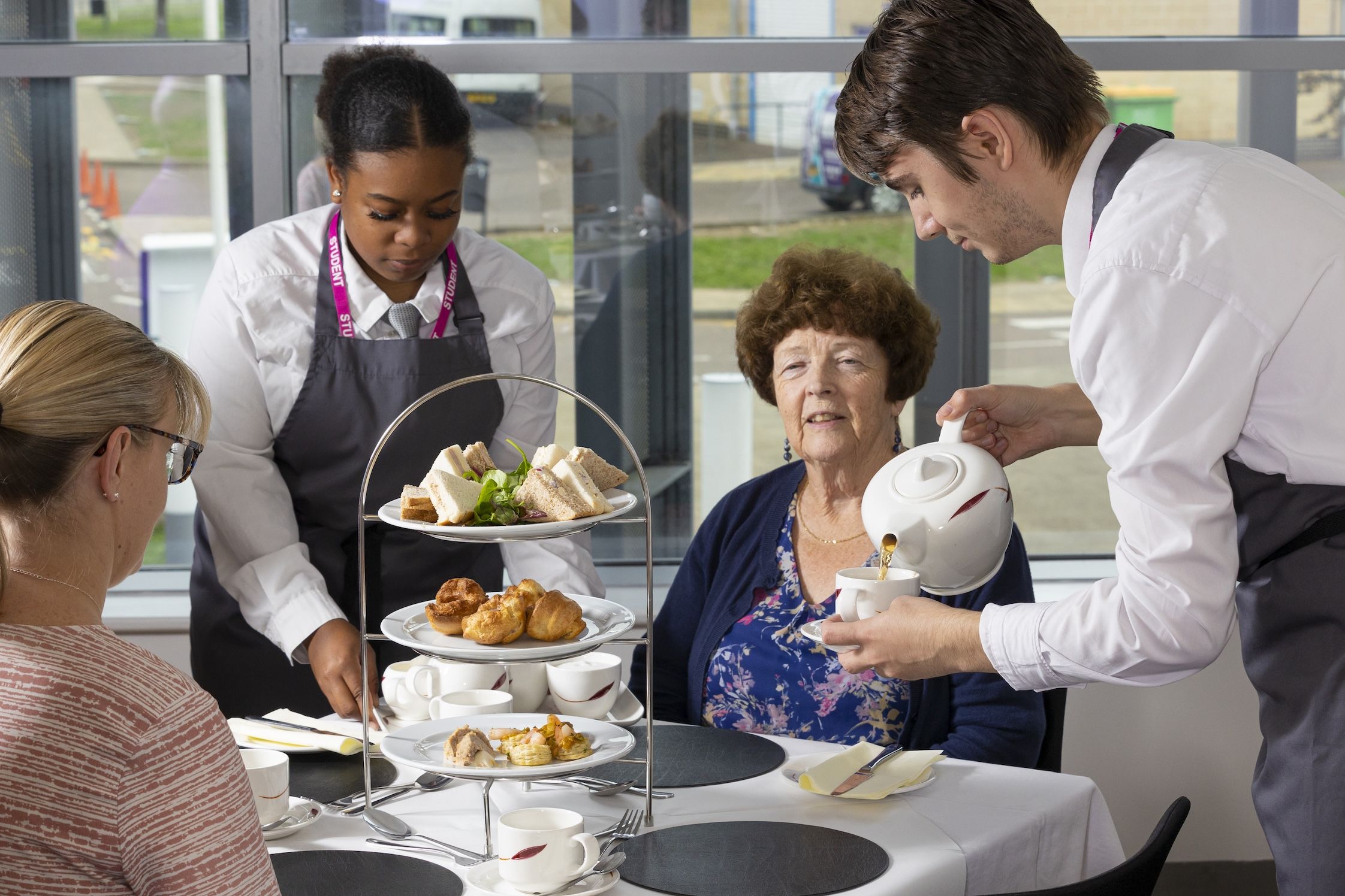 Students serving afternoon tea