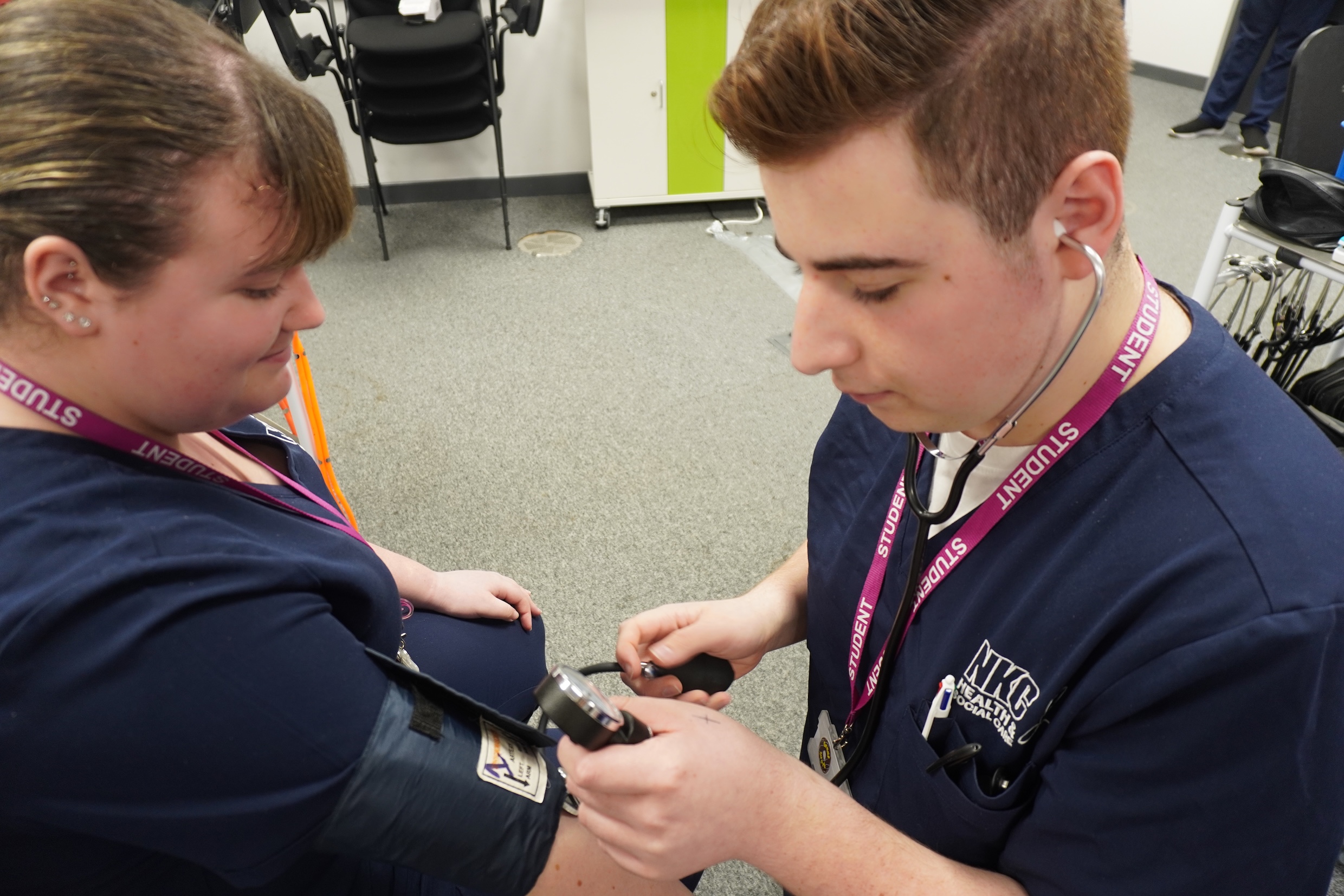 A student checks another students blood pressure