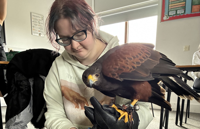 Student Holding Bird of Prey
