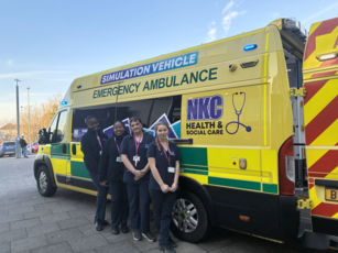 Students Standing in front of ambulance